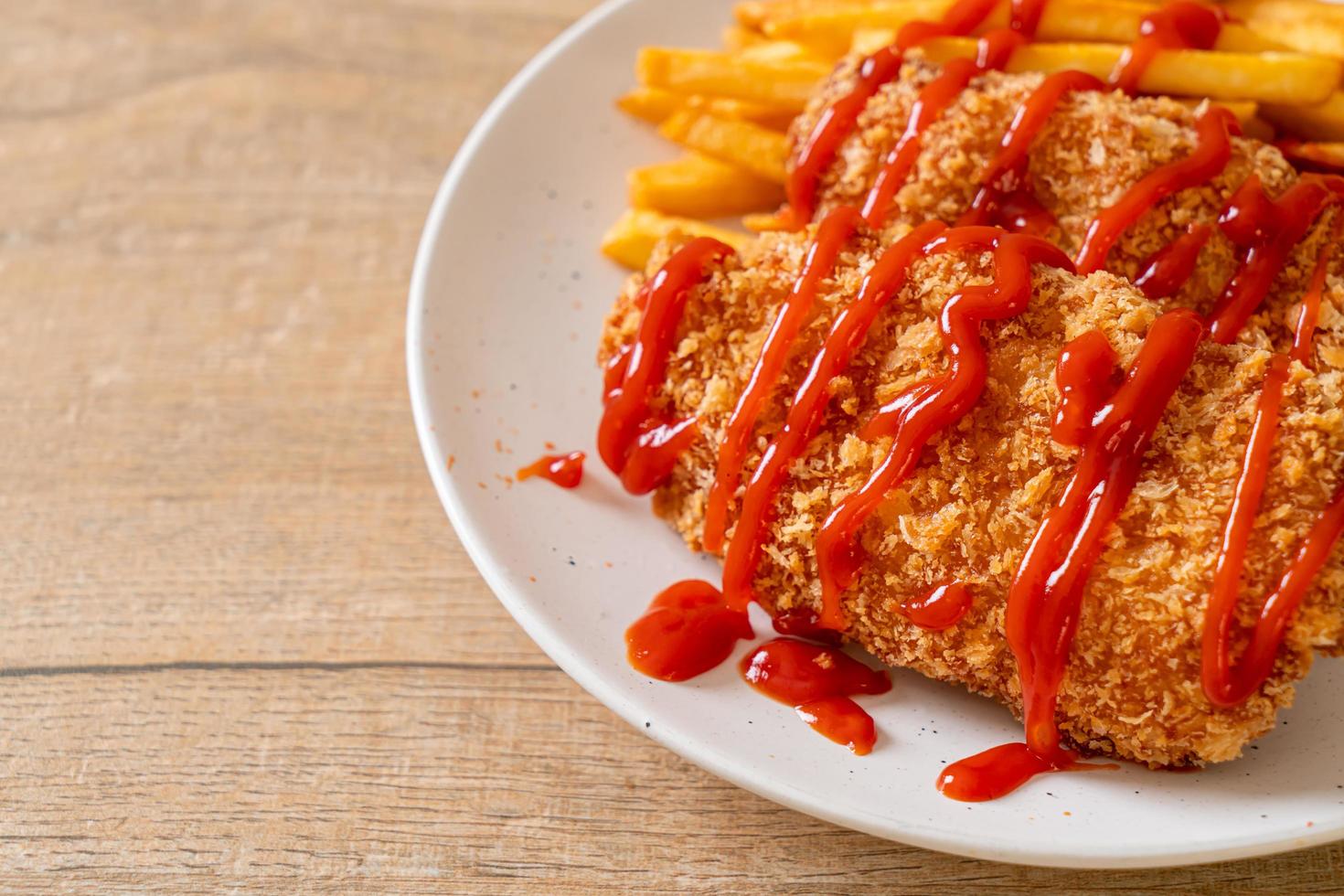 Fried chicken breast fillet steak with French fries and ketchup photo