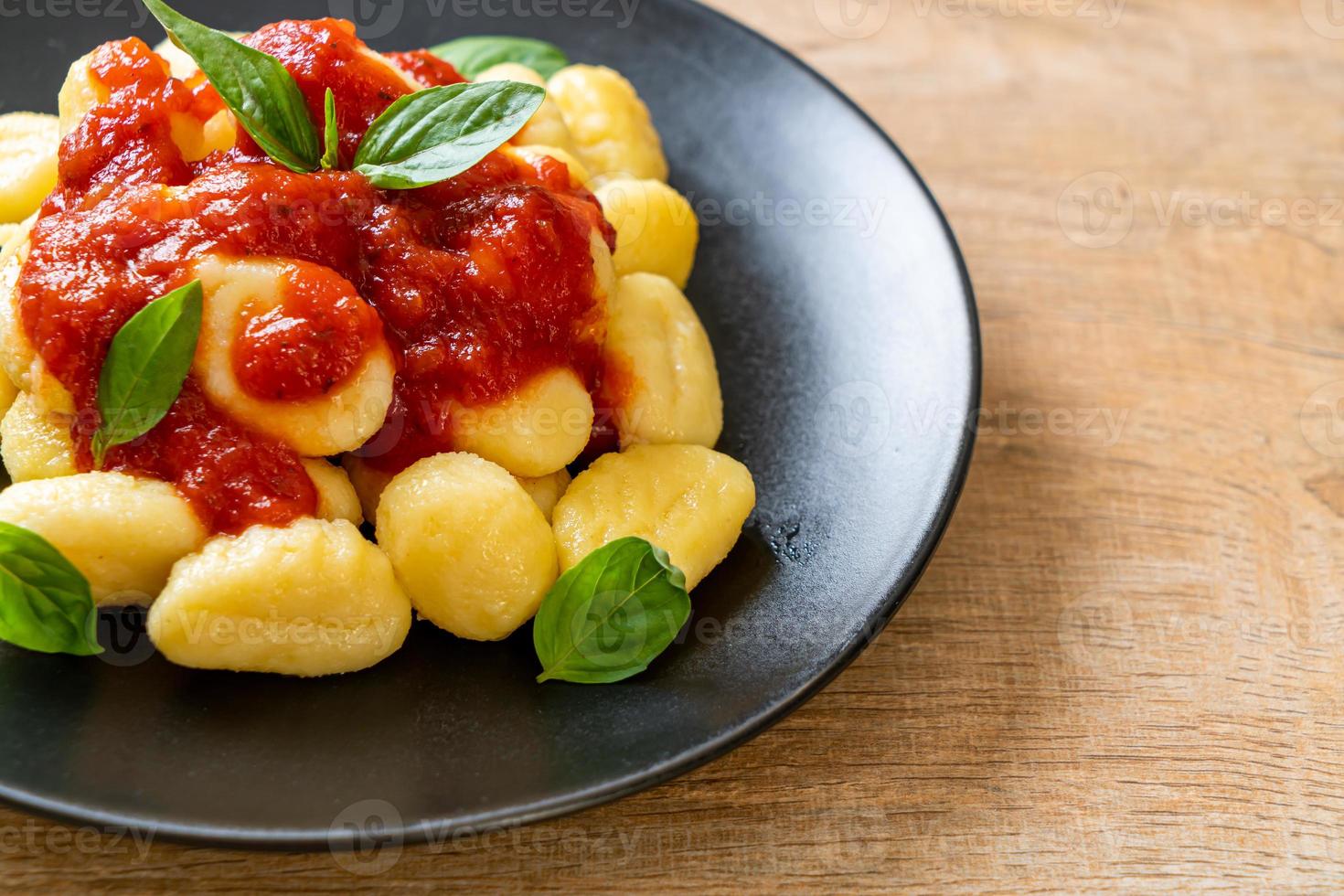 Gnocchi in tomato sauce with cheese - Italian food style photo