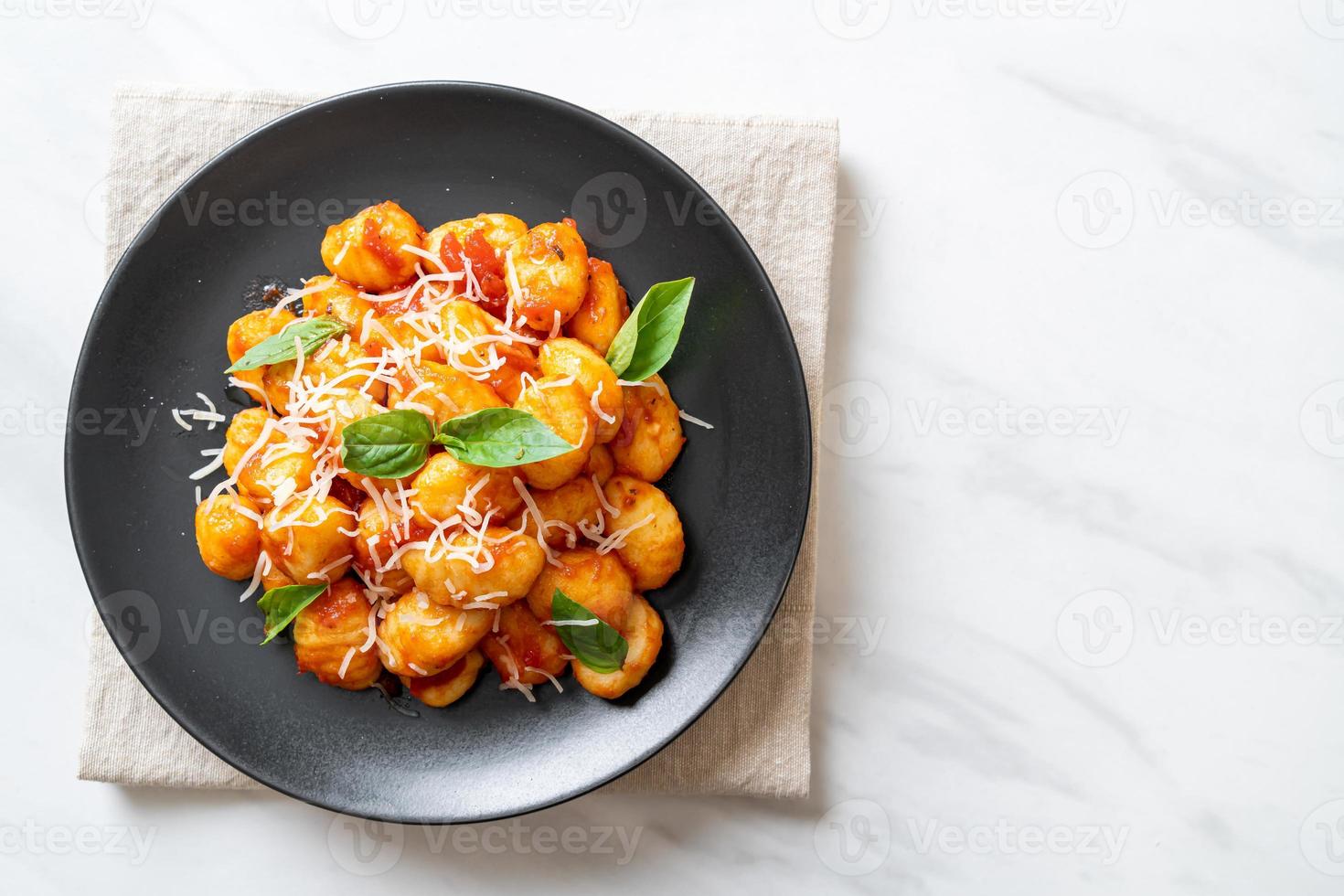 Gnocchi in tomato sauce with cheese - Italian food style photo