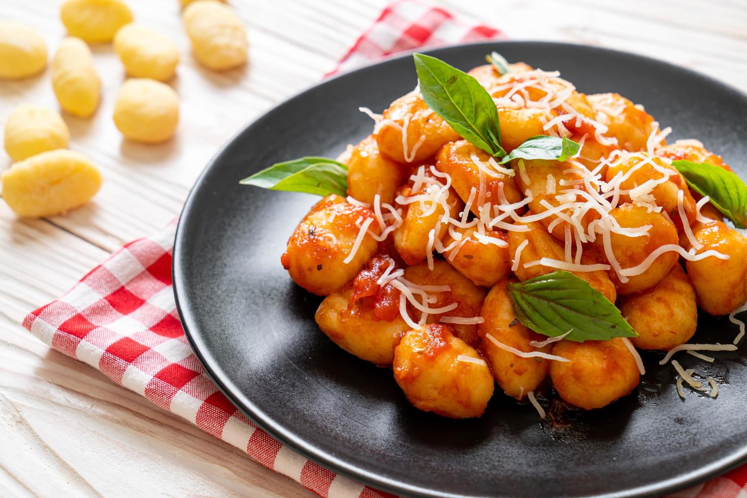 Gnocchi in tomato sauce with cheese - Italian food style photo