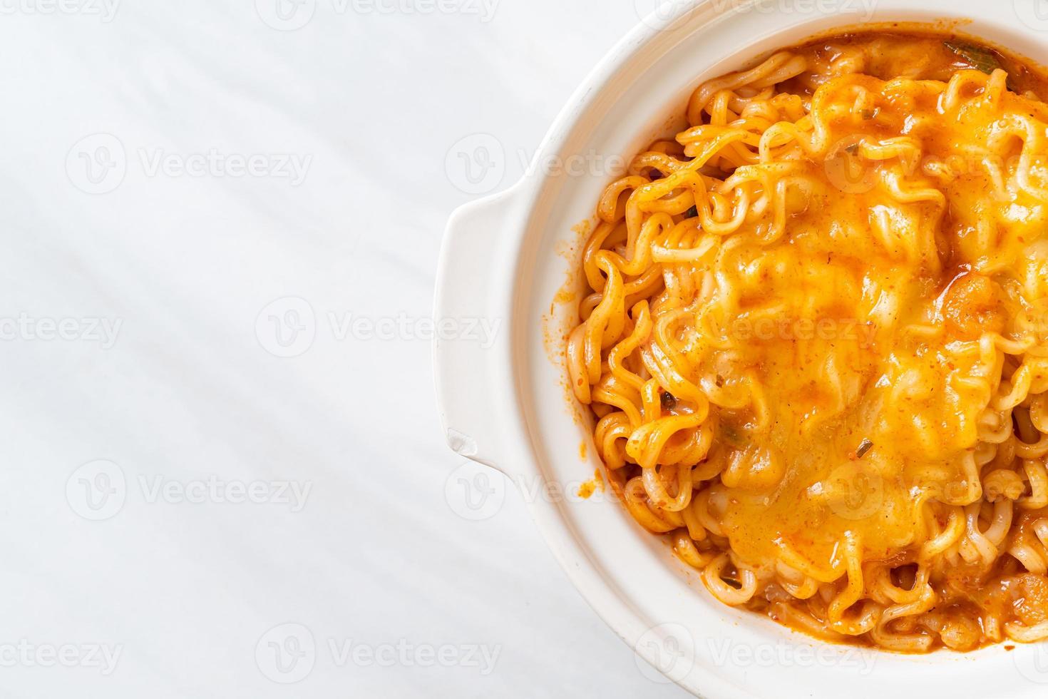 Spicy instant noodle bowl with mozzarella cheese photo