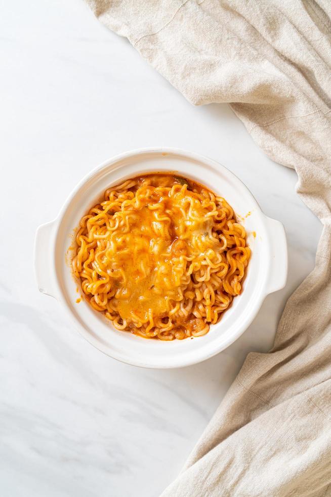 Spicy instant noodle bowl with mozzarella cheese photo