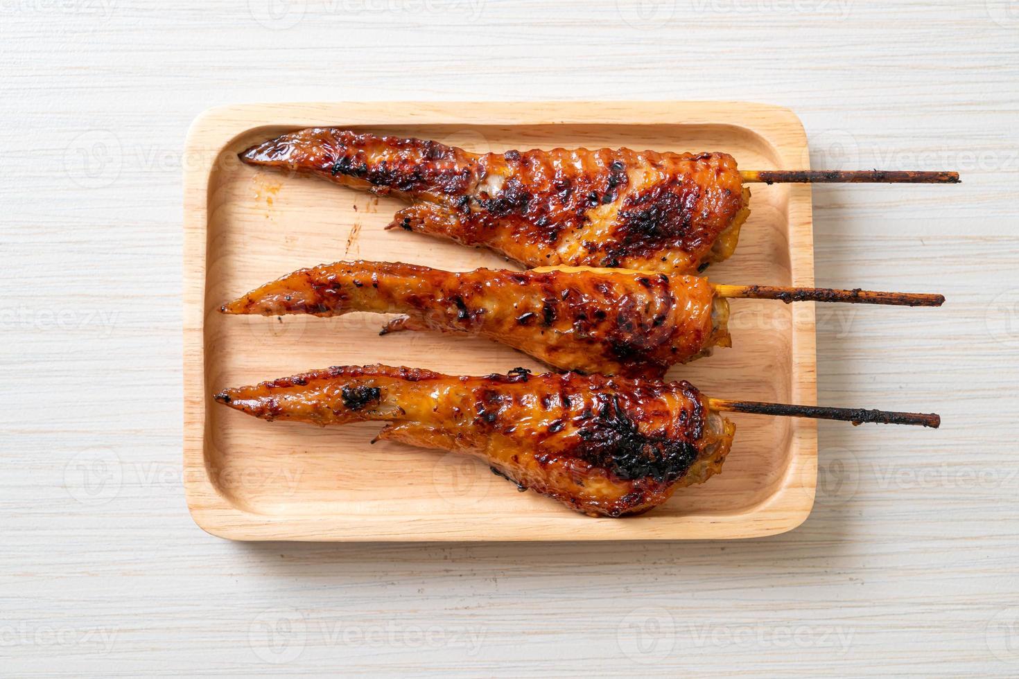 Grilled or barbecue chicken wings skewer with sticky rice photo