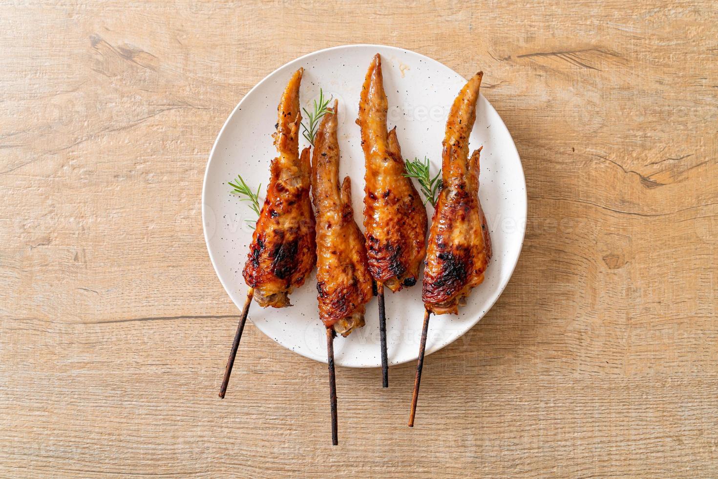 Grilled or barbecue chicken wings skewer with sticky rice photo