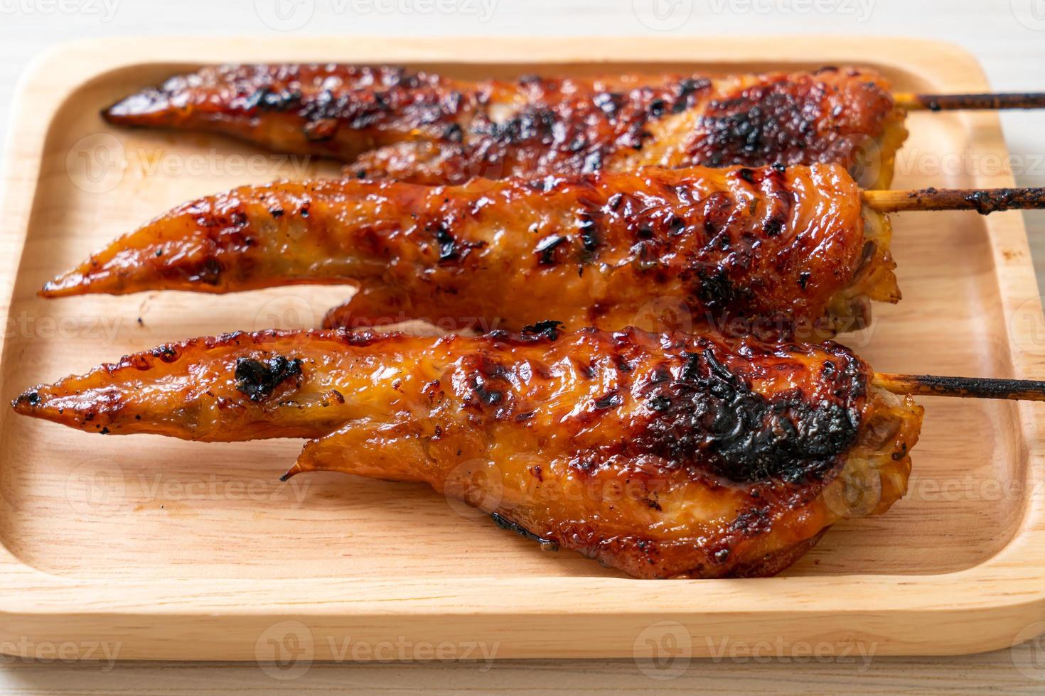 Grilled or barbecue chicken wings skewer with sticky rice photo