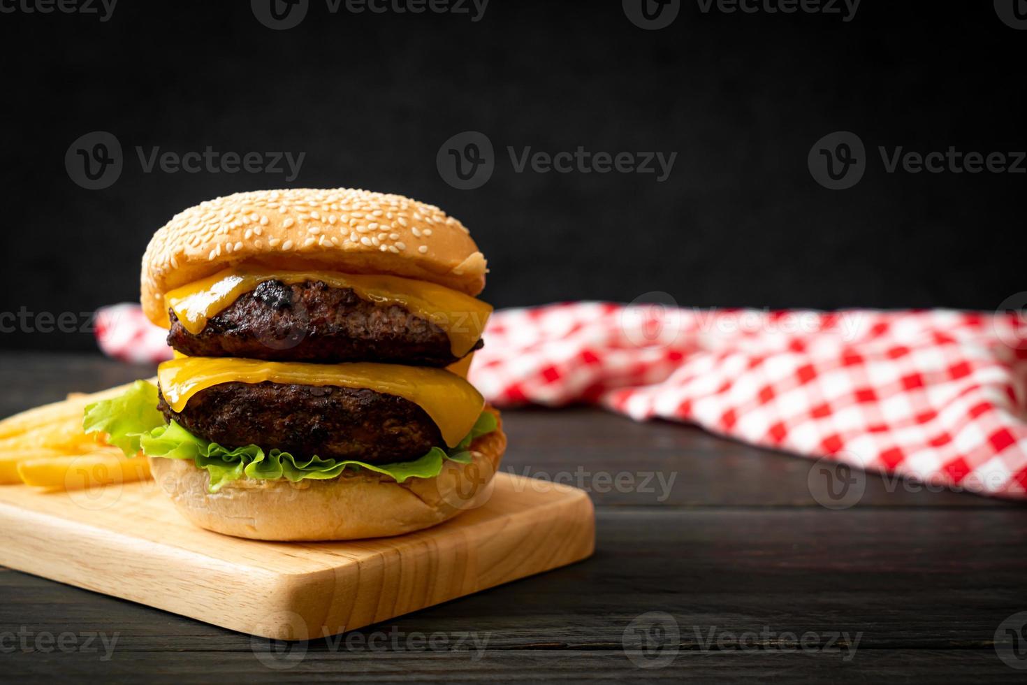 Hamburger or beef burgers with cheese and french fries - unhealthy food style photo