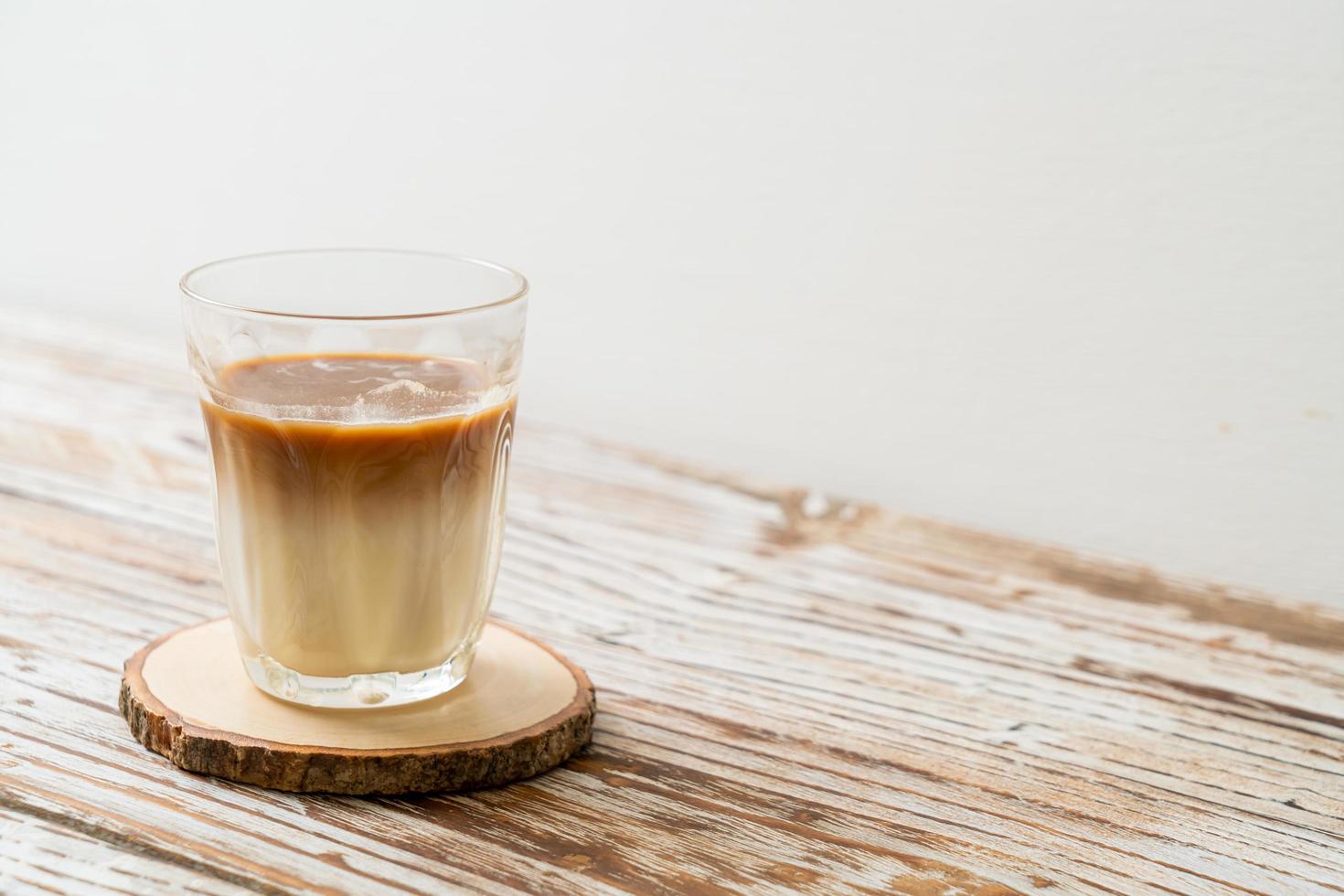 Glass of latte coffee, coffee with milk on wood background photo