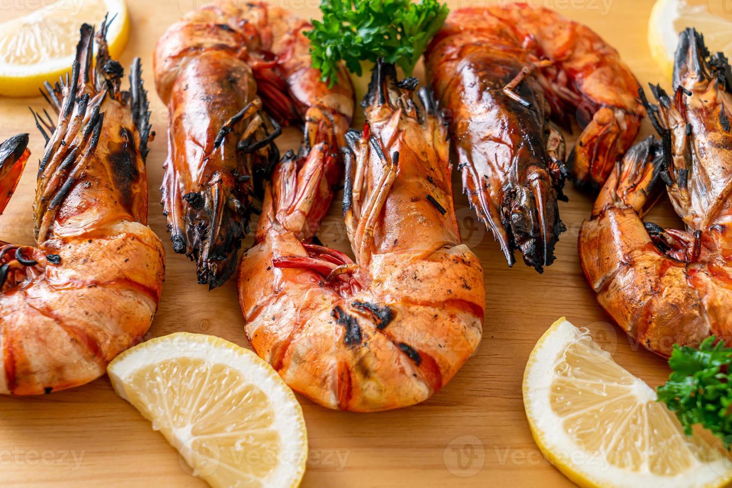 Grilled tiger prawns or shrimps with lemon on a plate photo