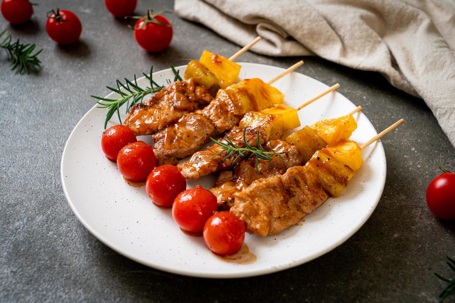 Grilled pork barbecue skewer on plate photo