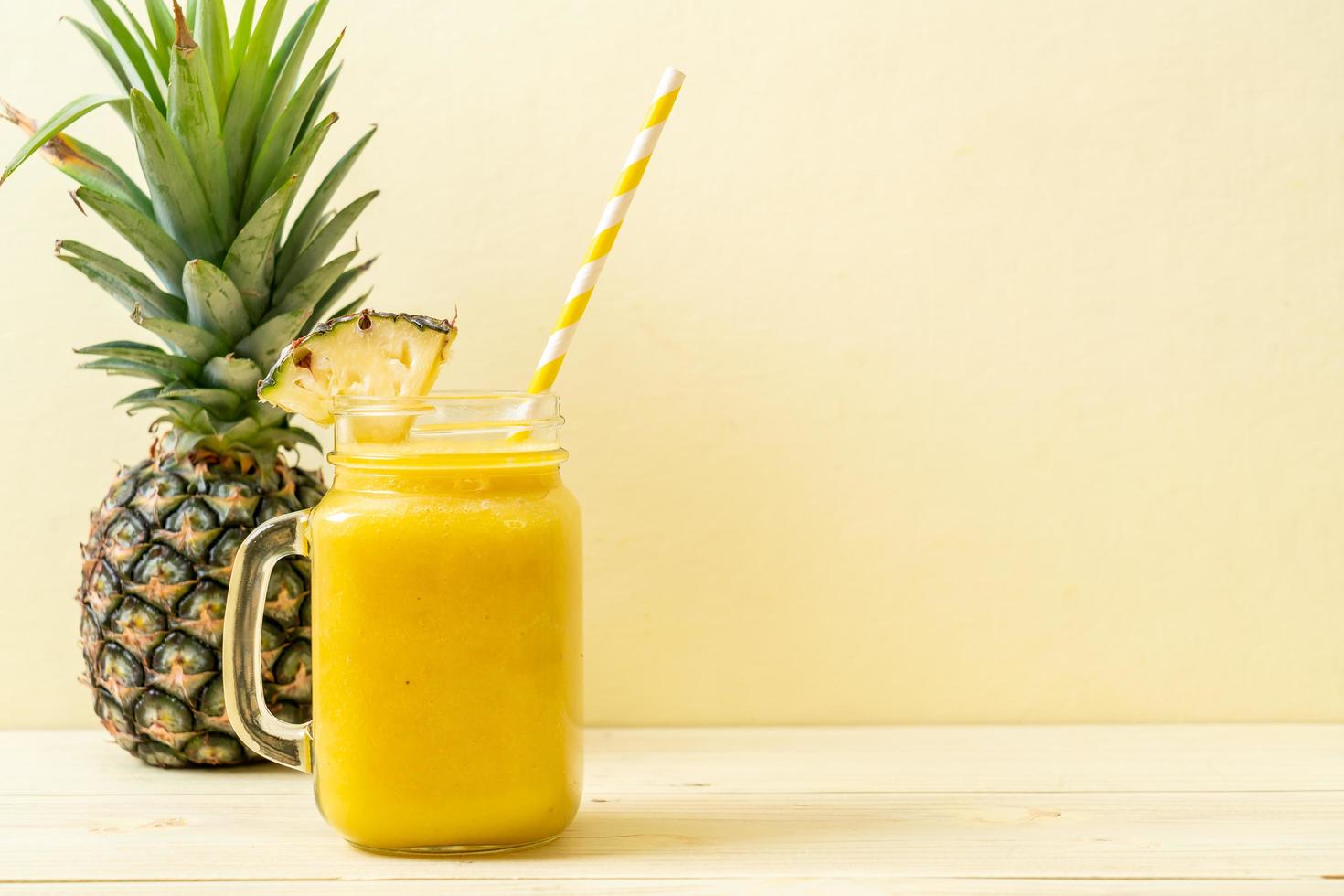 Fresh pineapple smoothie glass on wood table - Healthy Drink photo