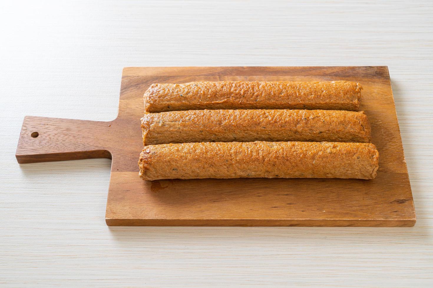 Fried Chinese fish cake or fish ball line on wood board photo