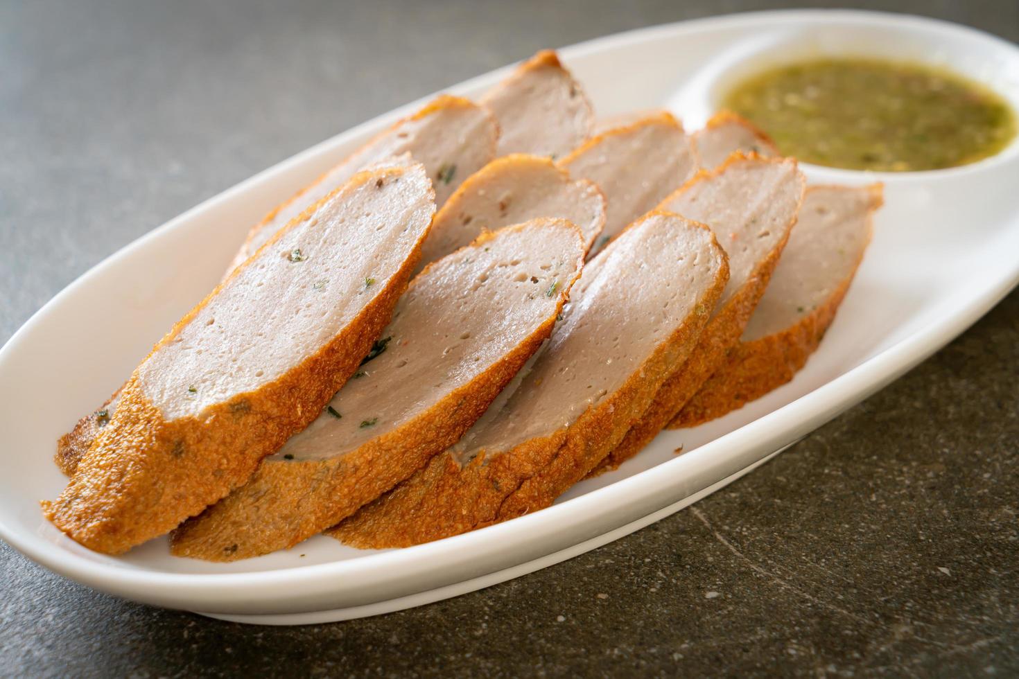 Fried Chinese fish cake or fish ball line sliced with spicy seafood
