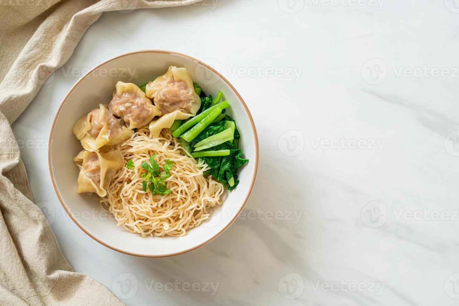 Dried egg noodles with pork wonton or pork dumplings without soup Asian food style photo