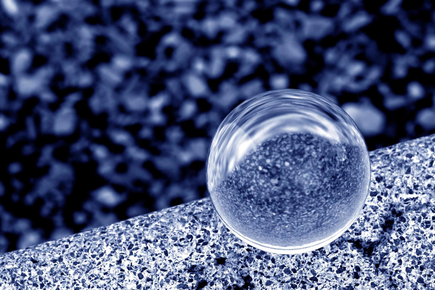 A lens ball in blue monochrome photo