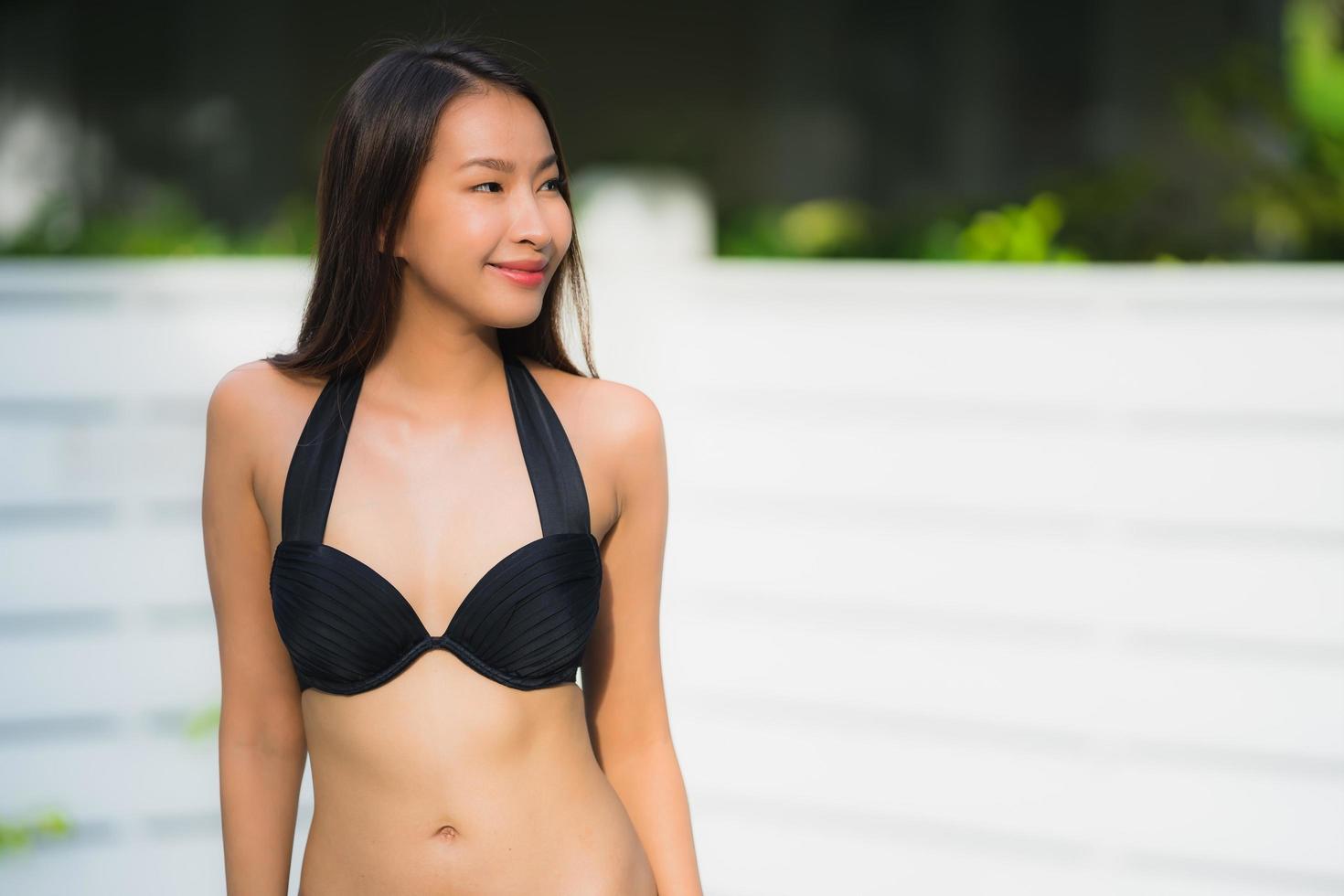 Portrait beautiful young asian woman happy smile relax around outdoor swimming pool photo