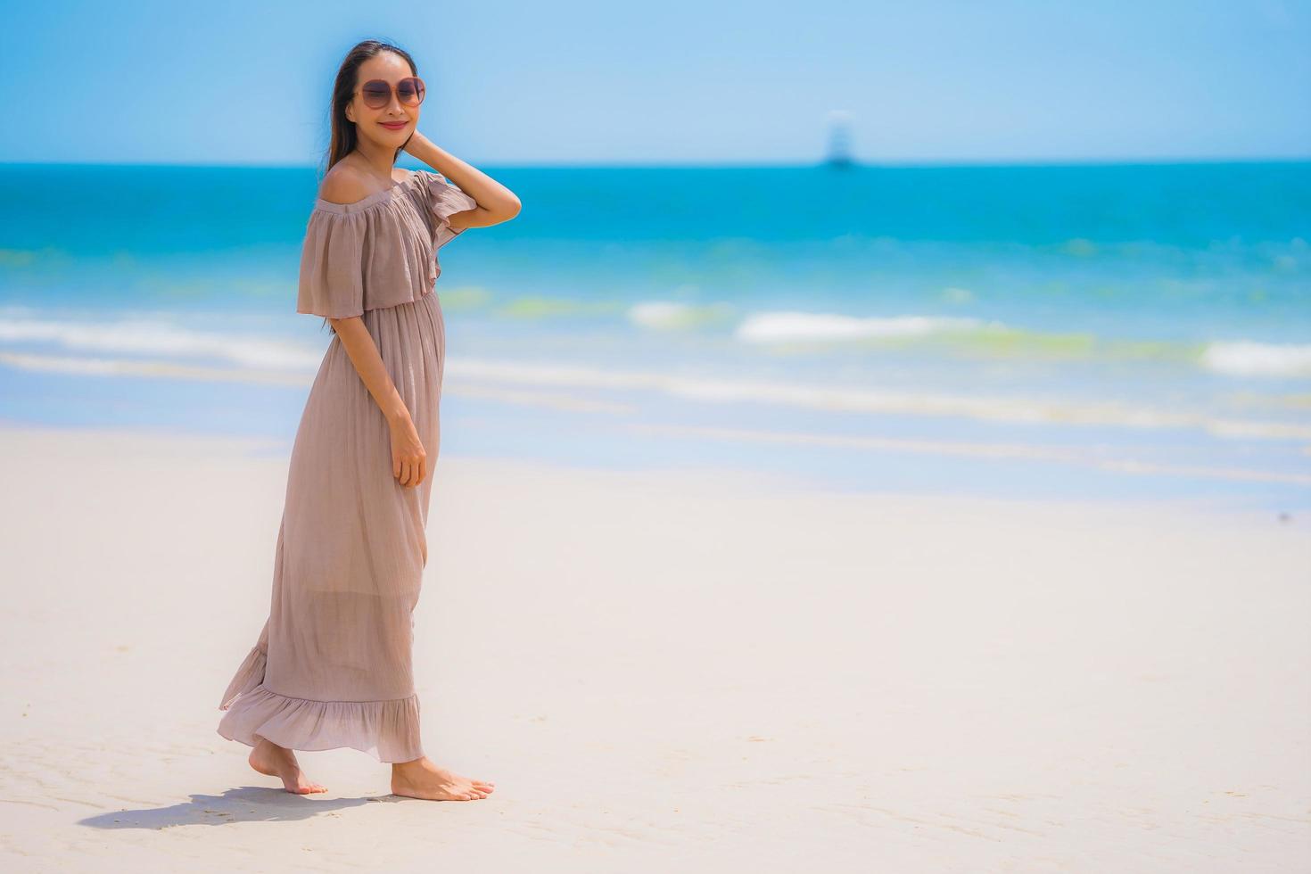 Portrait beautiful young asian woman happy smile relax on the tropical beach sea ocean photo