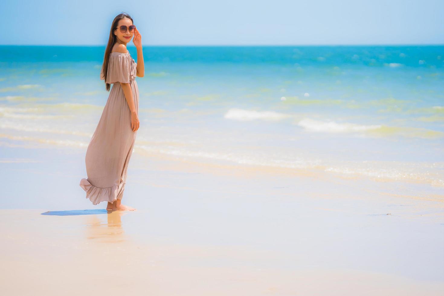 Portrait beautiful young asian woman happy smile relax on the tropical beach sea ocean photo