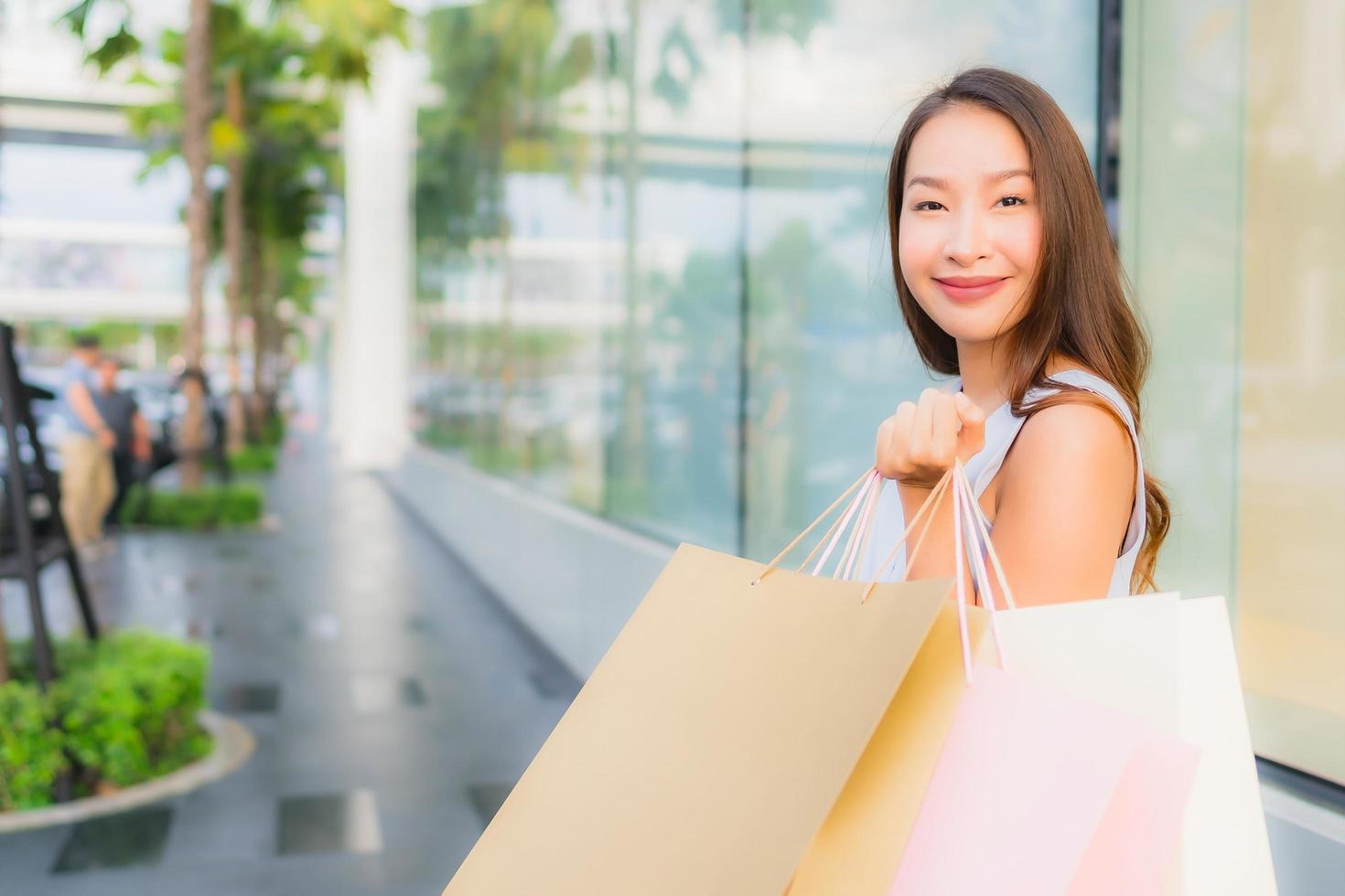 Portrait beautiful young asian woman happy and smile with shopping bag from department store photo