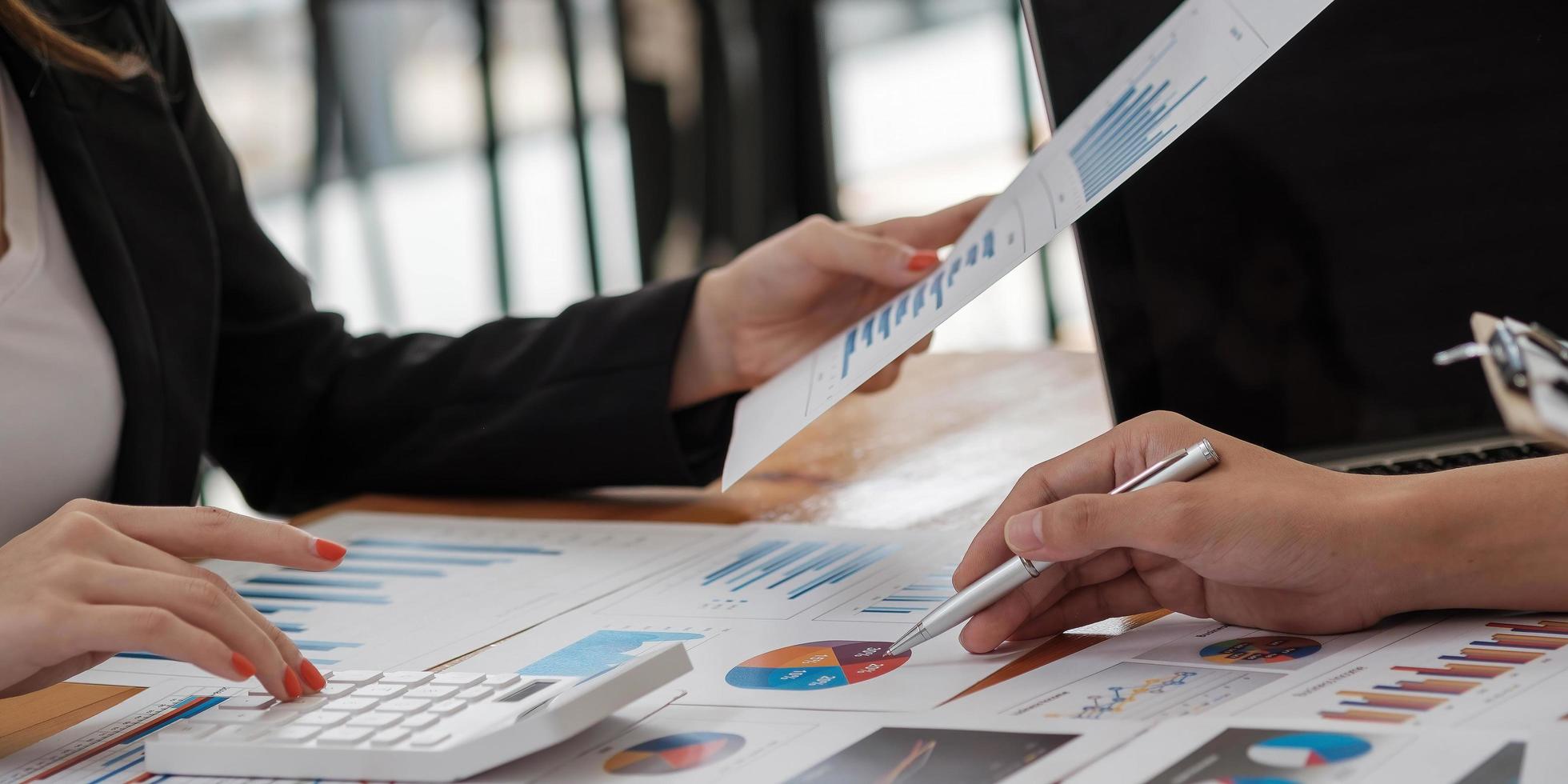 Business advisor analyzing financial figures denoting the progress in the work of the company photo