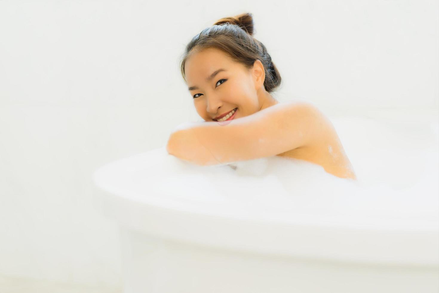 Portrait beautiful young asian woman take a bathtub in bathroom photo