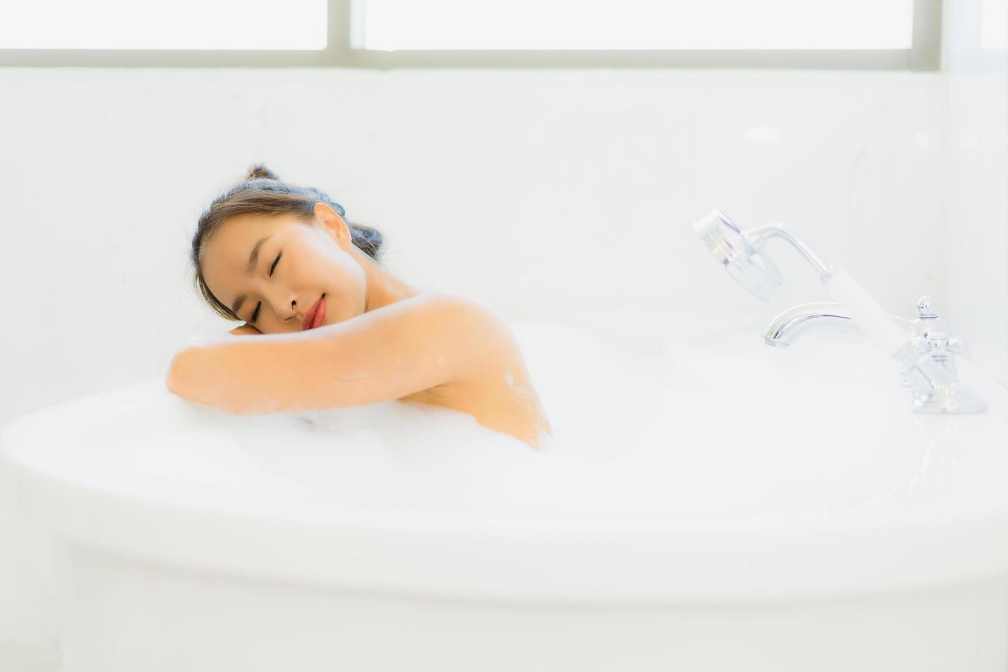 Portrait beautiful young asian woman take a bathtub in bathroom photo