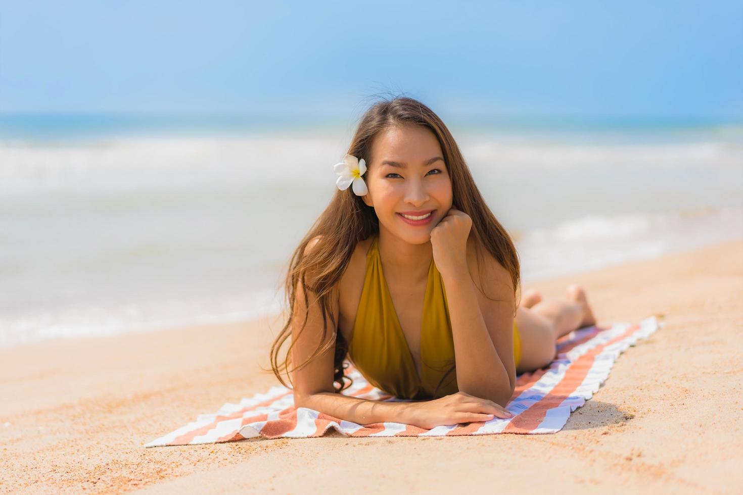 Portrait beautiful young asian woman smile happy on the beach and sea photo