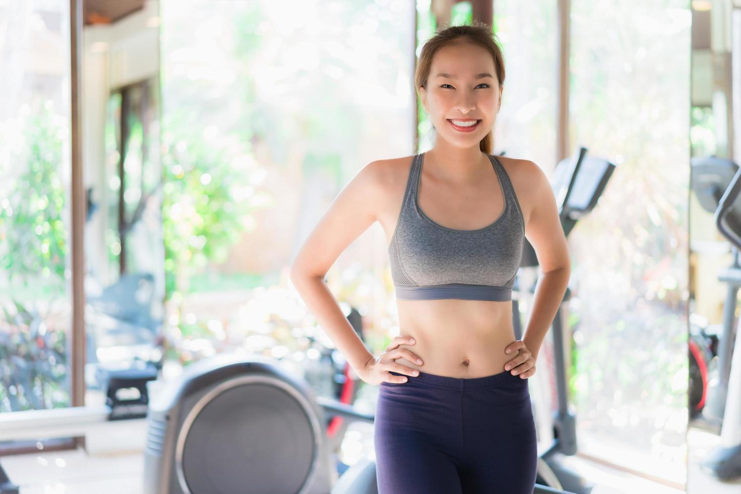 Portrait beautiful young asian woman exercise with fitness equipment in gym interior photo