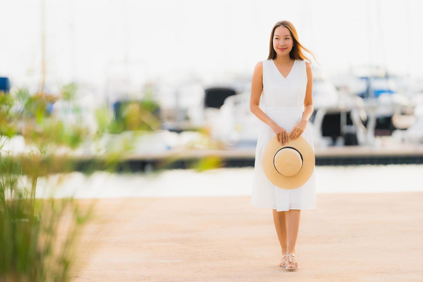 Portrait beautiful young asian woman leisure smile happy relax around yacht port photo