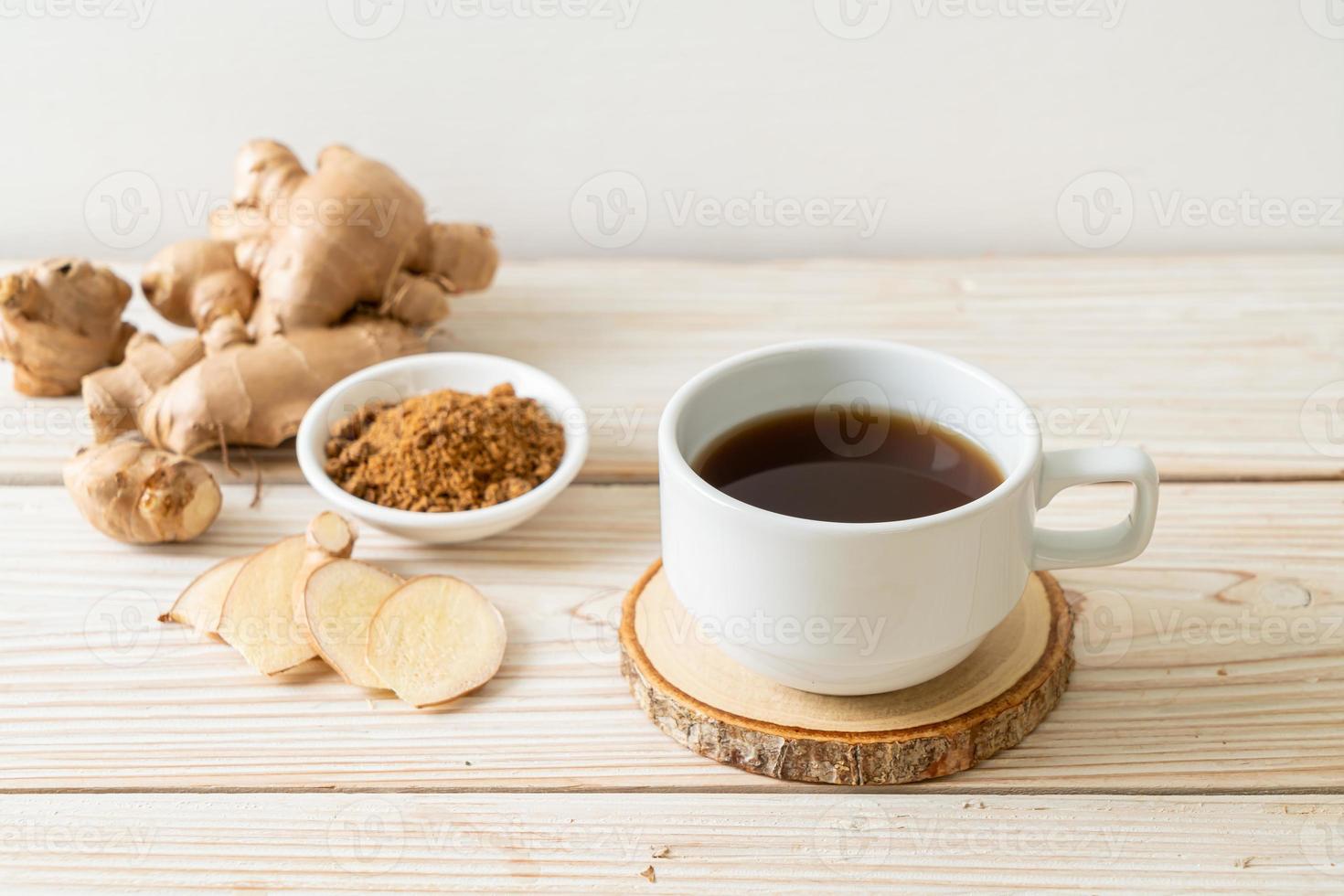 Hot and sweet ginger juice glass with ginger roots - Healthy drink style photo