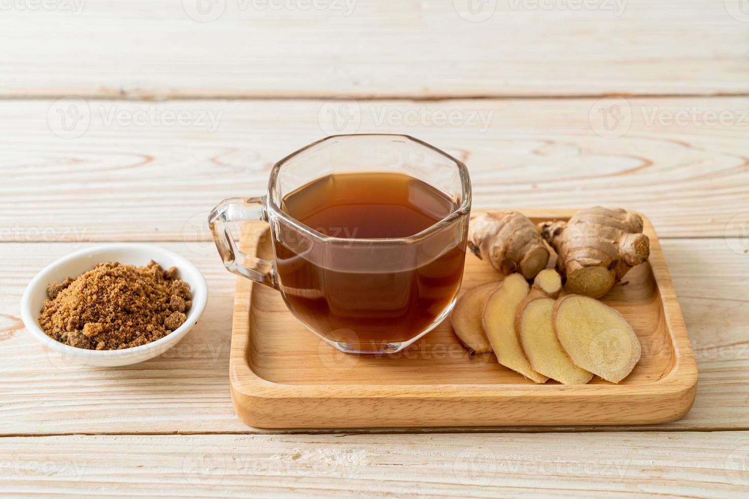 Hot and sweet ginger juice glass with ginger roots - Healthy drink style photo