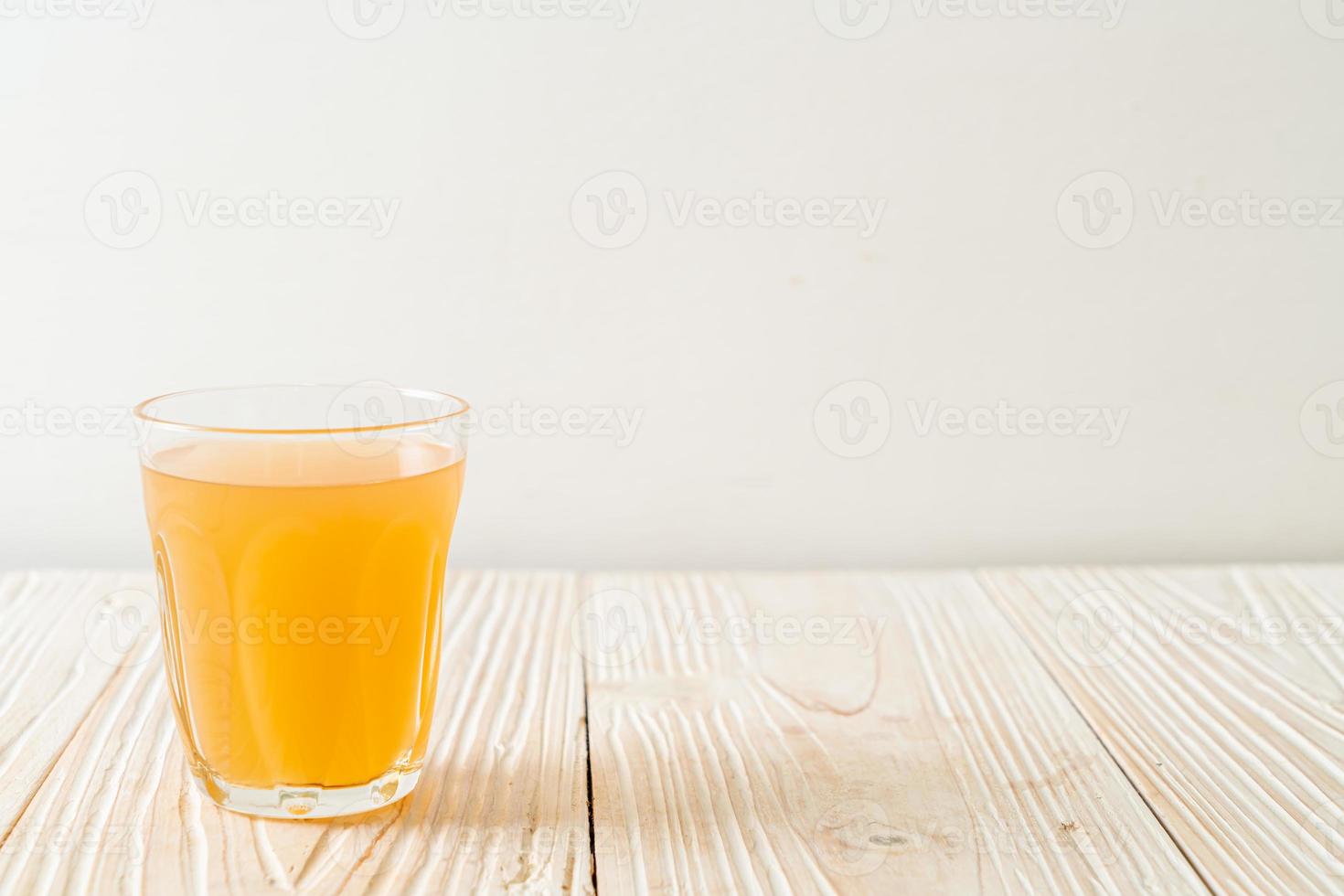 Fresh and hot ginger juice glass with ginger roots - Healthy drink style photo