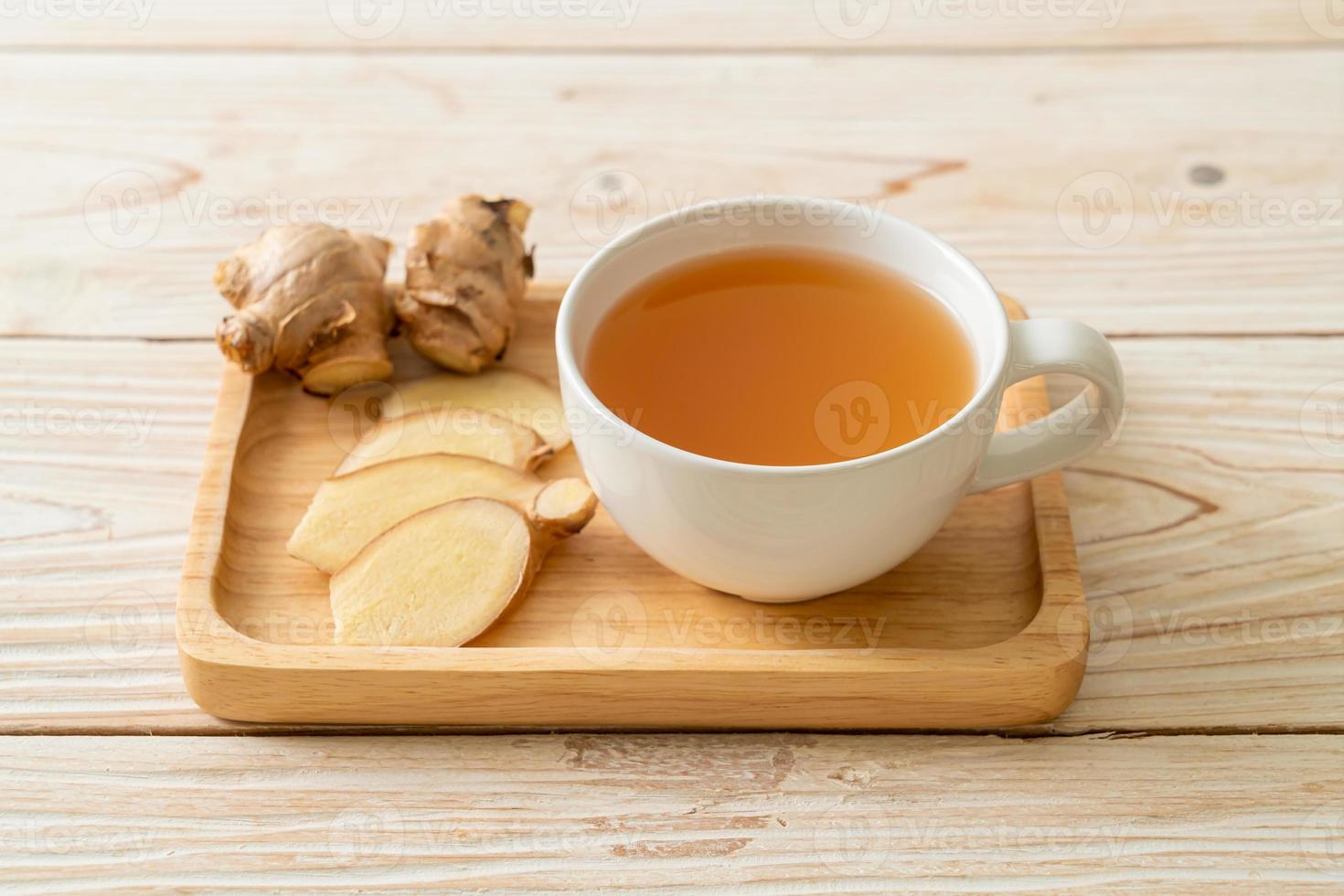 Fresh and hot ginger juice glass with ginger roots - Healthy drink style photo