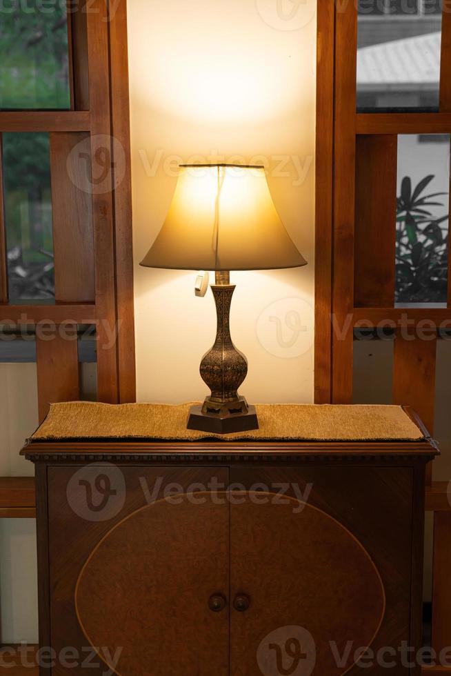 Beautiful vintage lamp decoration on vintage wood cabinet photo