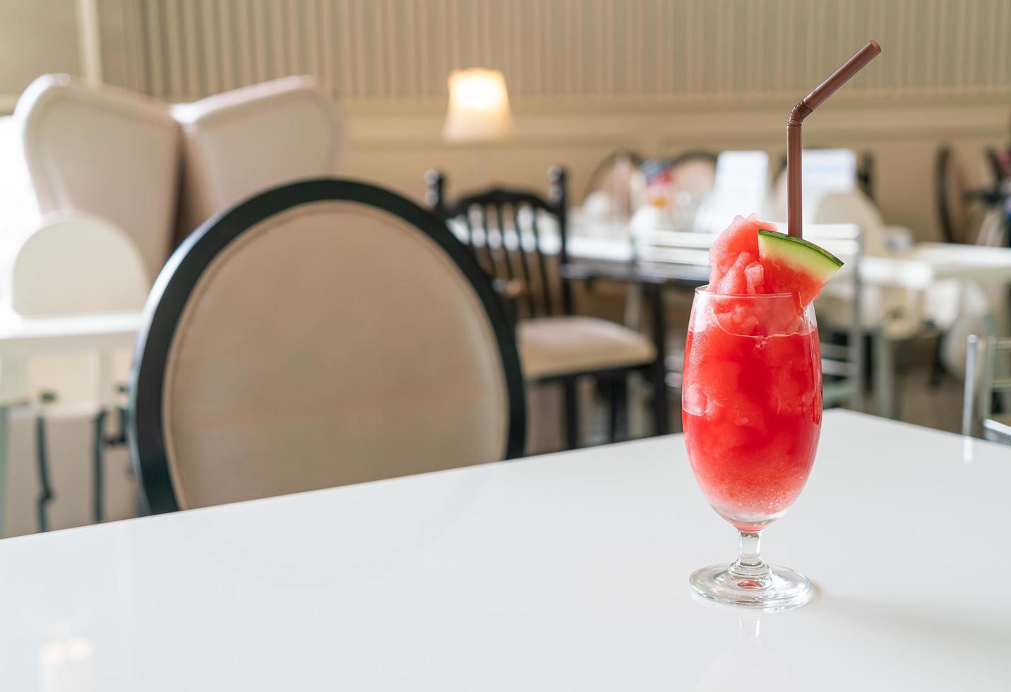 Fresh watermelon smoothie glass on table in cafe restaurant photo