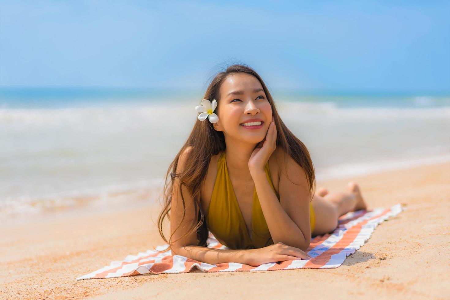 Portrait beautiful young asian woman smile happy on the beach and sea photo