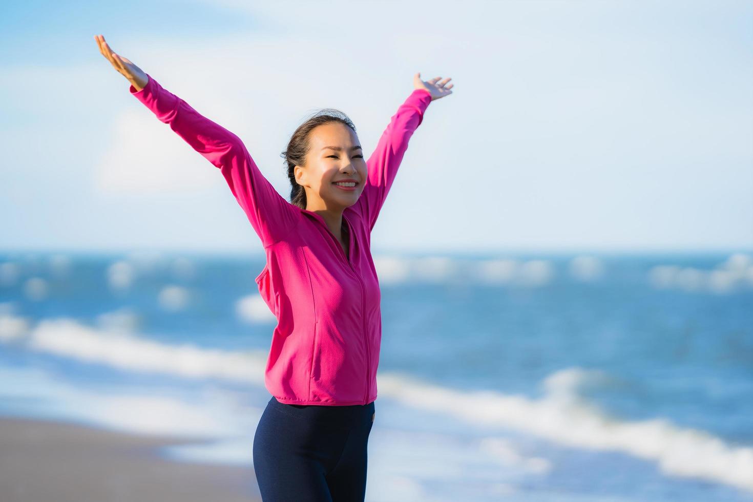 Portrait beautiful young asian woman running and exercising on the tropical outdoor nature beach sea ocean photo