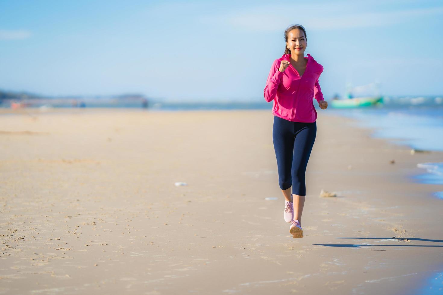 Portrait beautiful young asian woman running and exercising on the tropical outdoor nature beach sea ocean photo