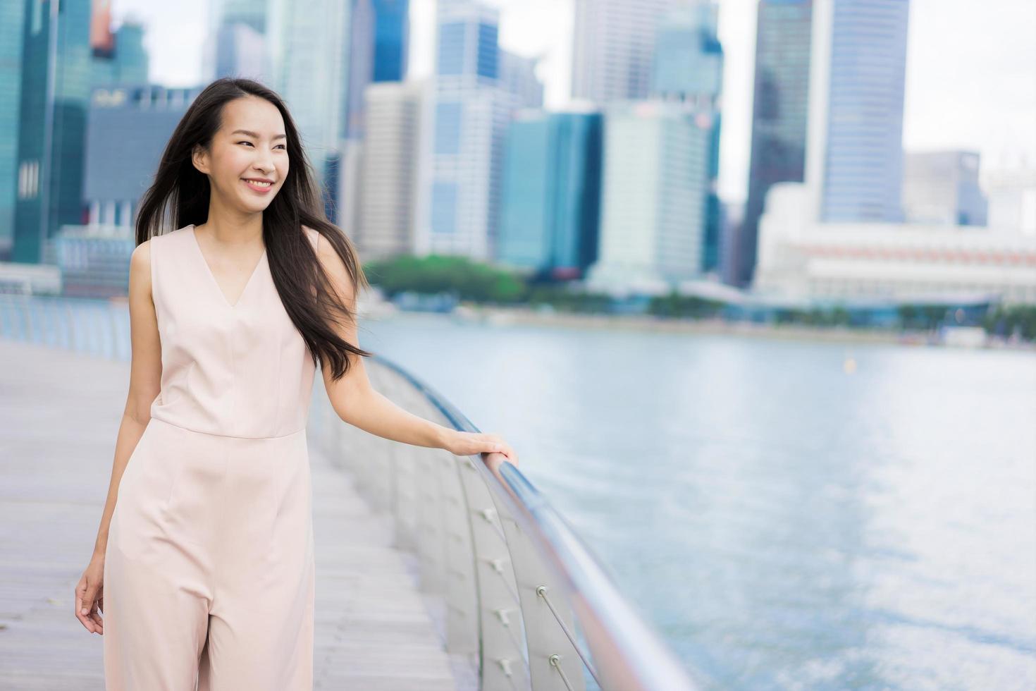 Beautiful asian woman smile and happy to travel in singapore city photo