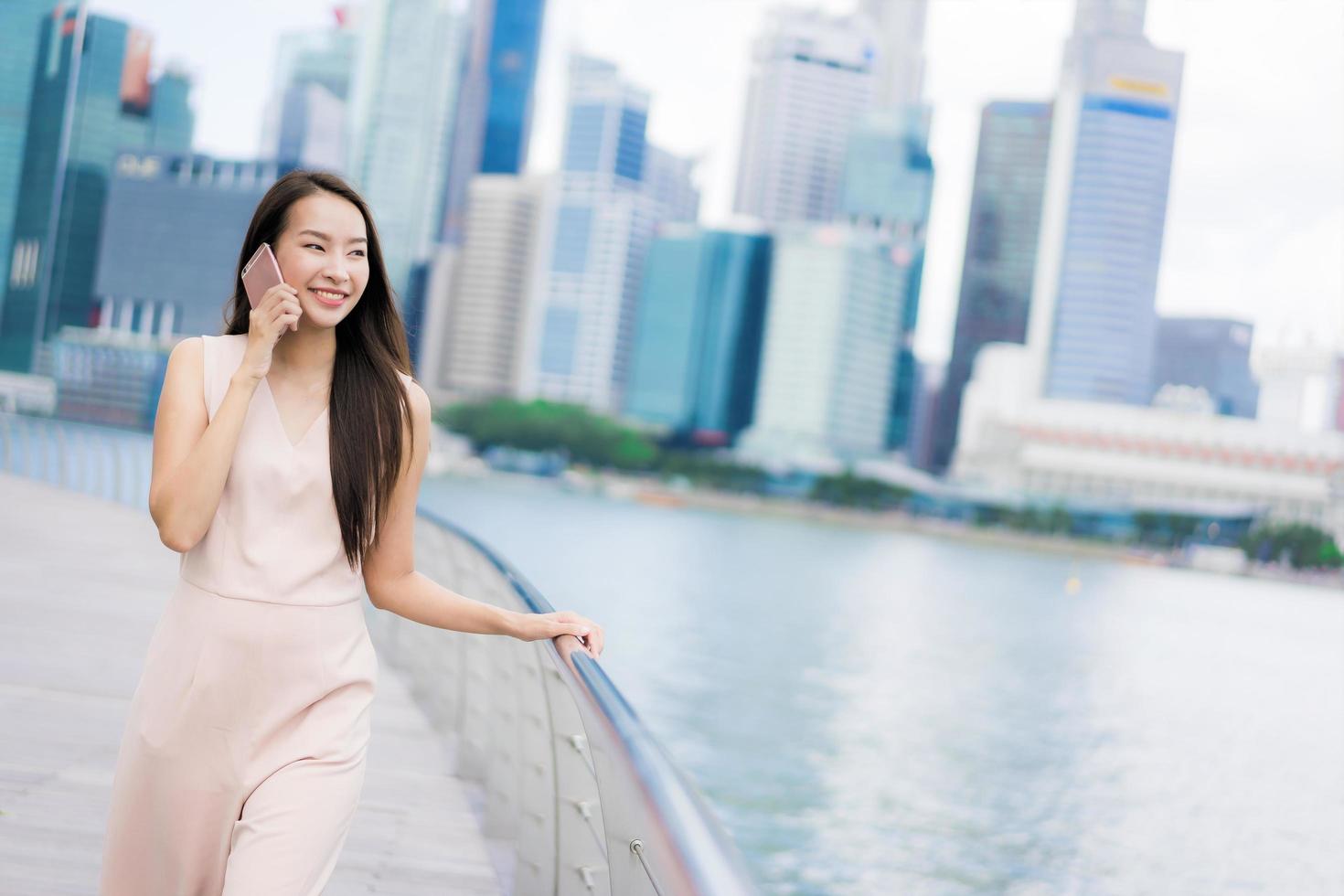 Asian woman using smartphone or mobile phone for talking or text photo