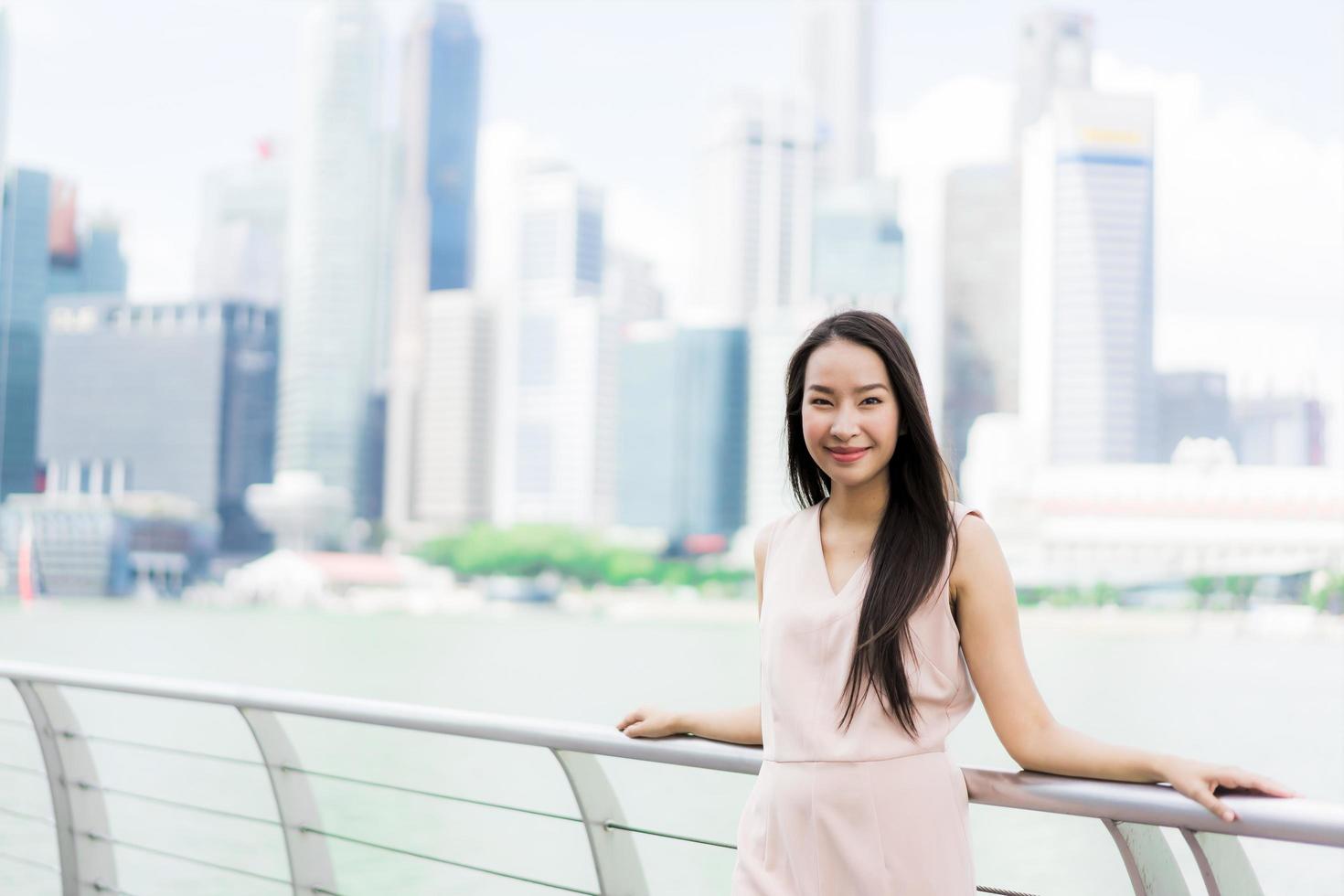 Beautiful asian woman smile and happy to travel in singapore city photo