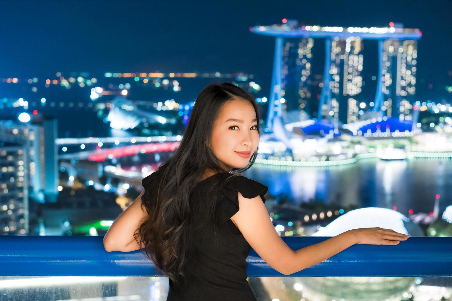 Beautiful Asian women smile and happy with singapore city view photo