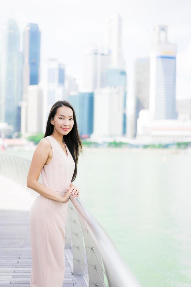 Beautiful asian woman smile and happy to travel in singapore city photo