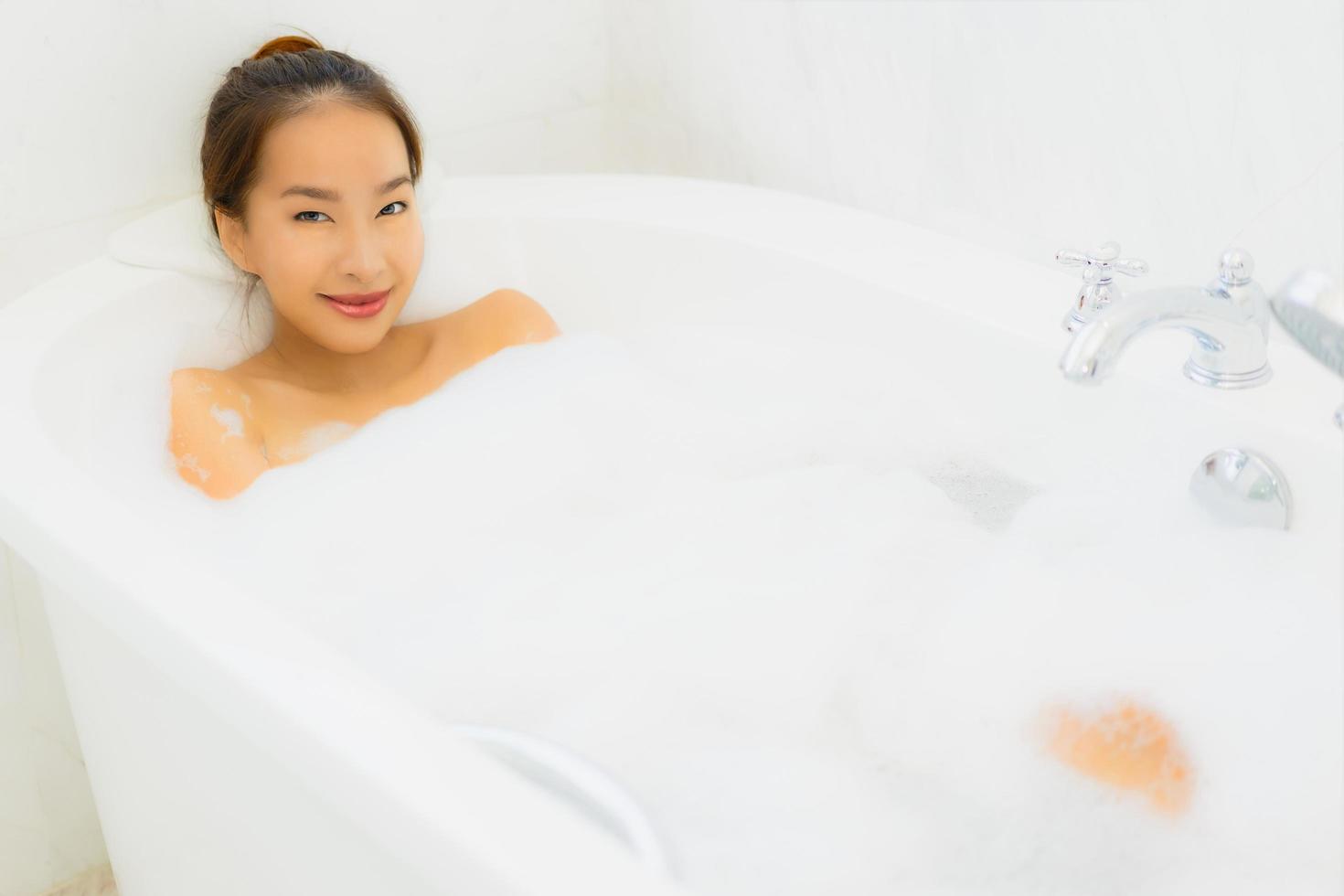 Portrait beautiful young asian woman take a bathtub in bathroom photo