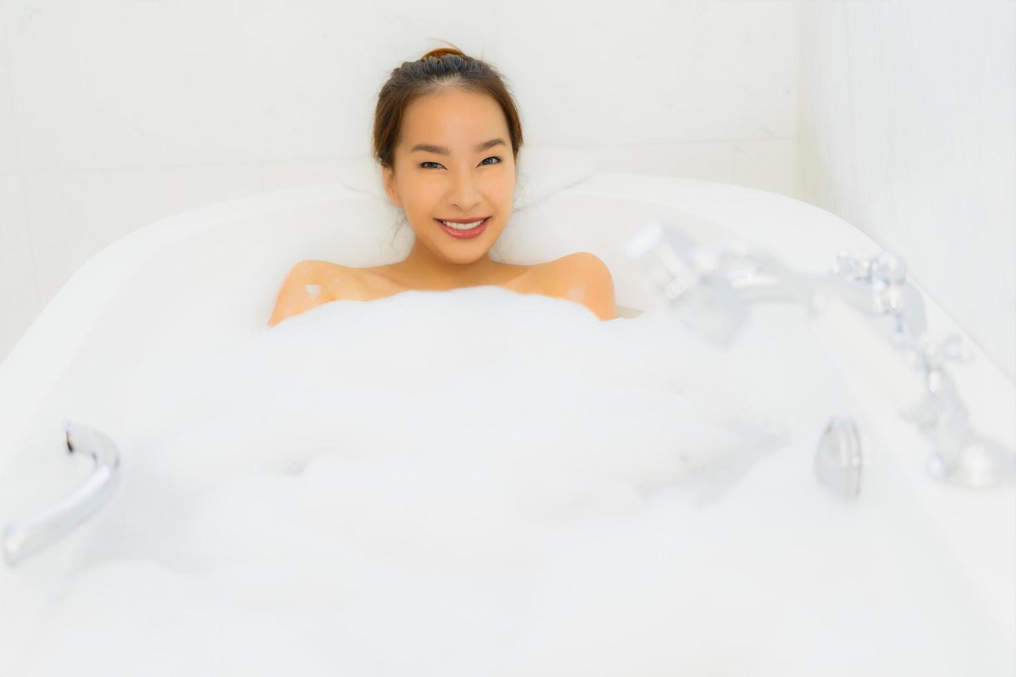 Portrait beautiful young asian woman take a bathtub in bathroom photo