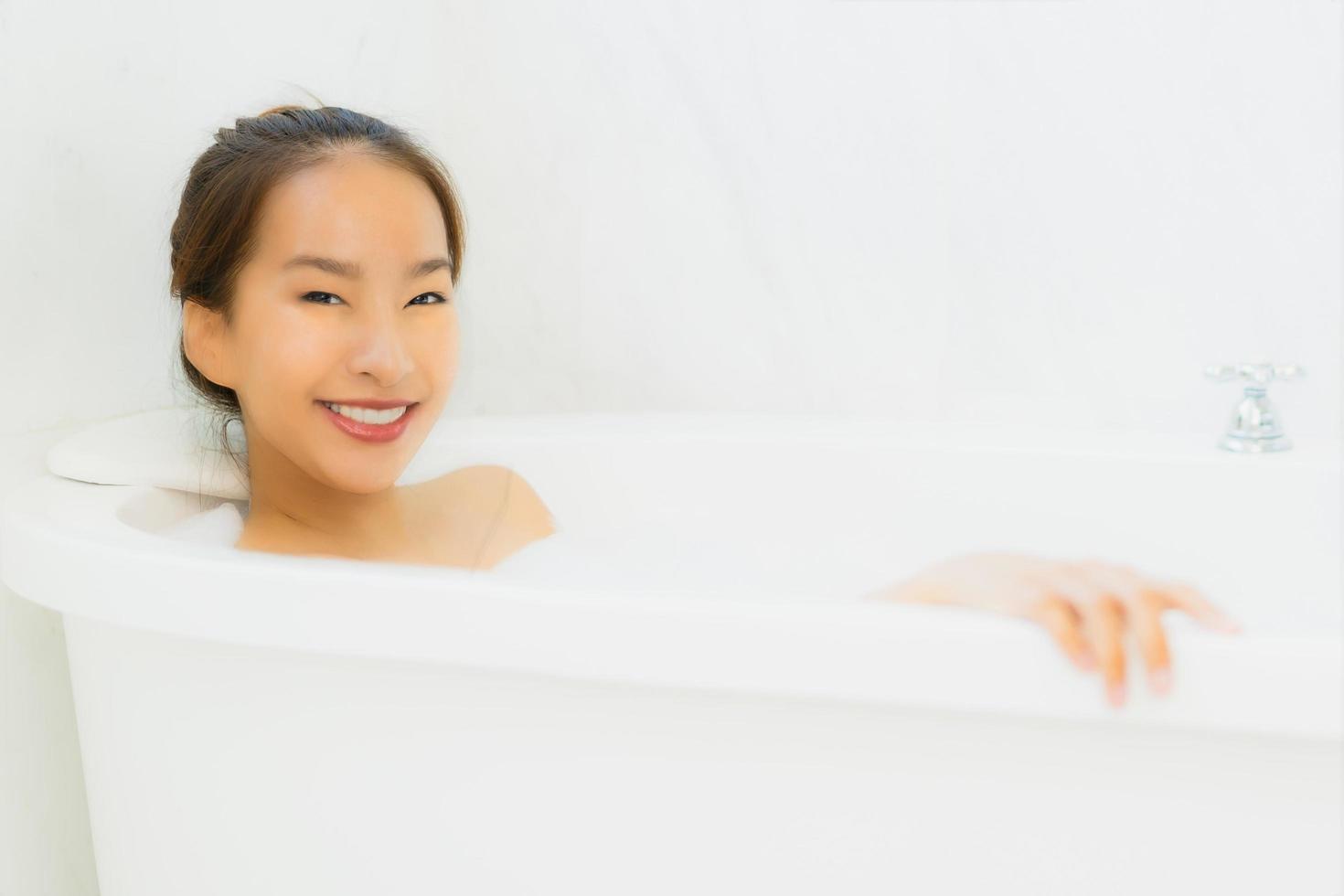 Portrait beautiful young asian woman take a bathtub in bathroom photo