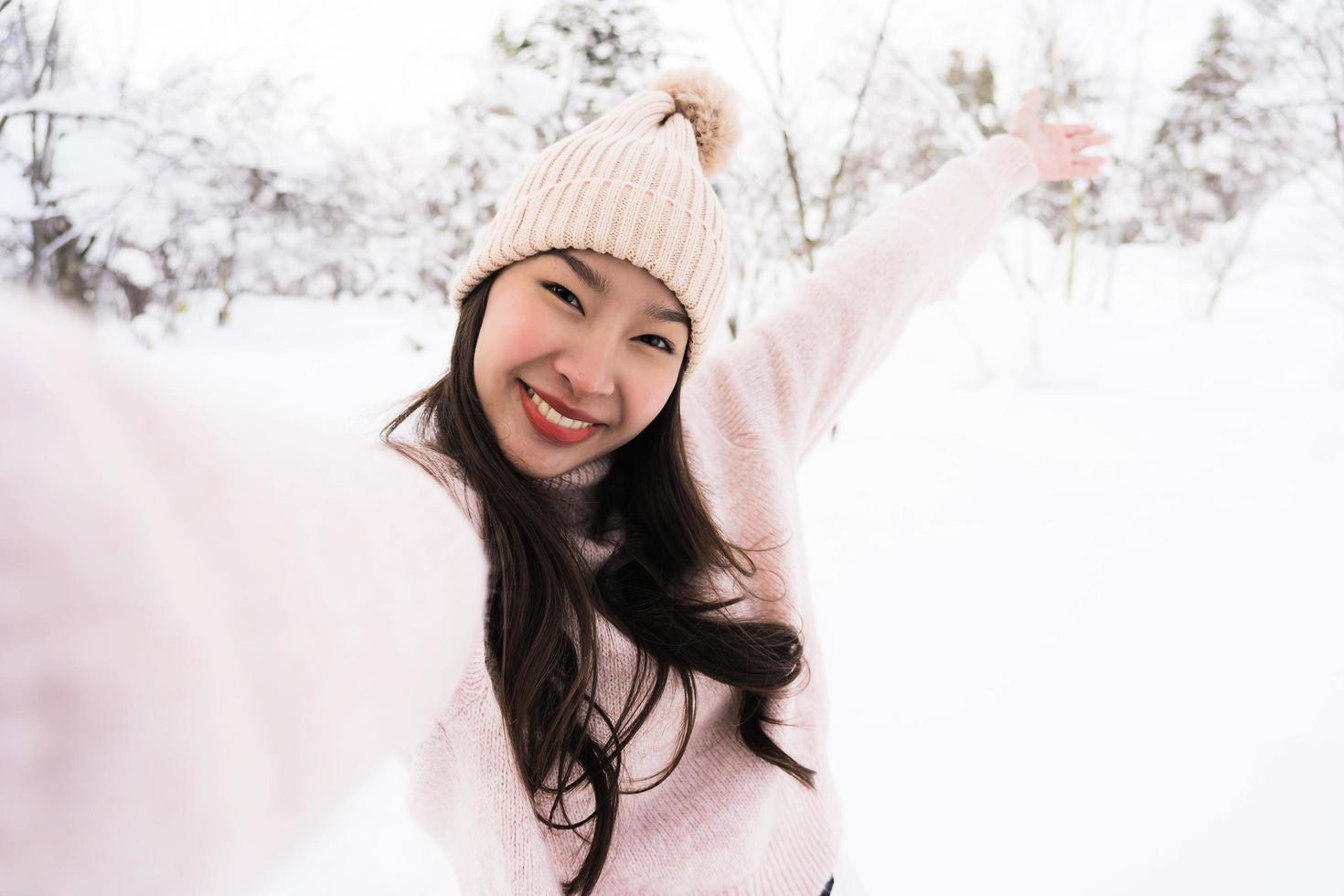 Portrait Young Beautiful asian woman smile happy travel and enjoy with snow winter season photo