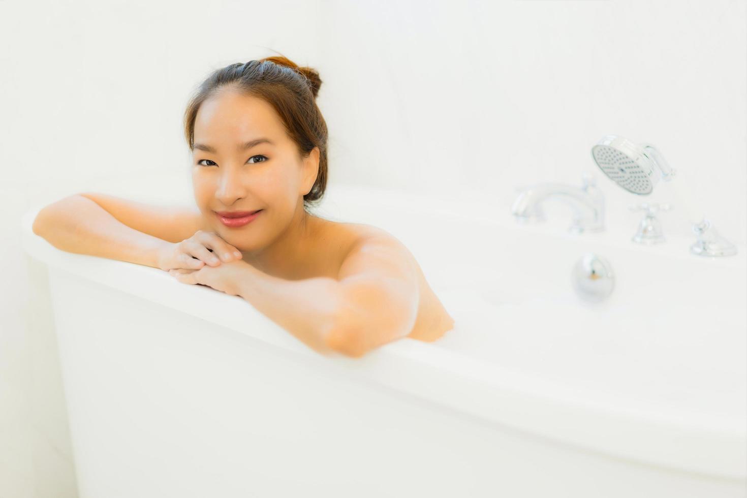 Portrait beautiful young asian woman take a bathtub in bathroom photo