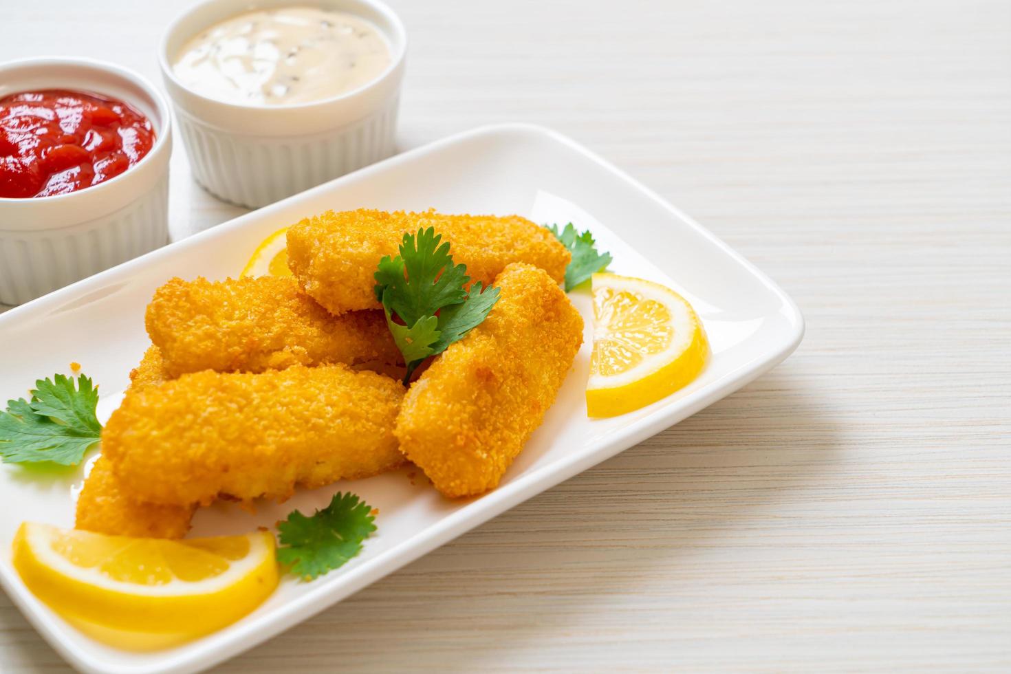 Fried fish finger sticks or french fries fish with sauce photo