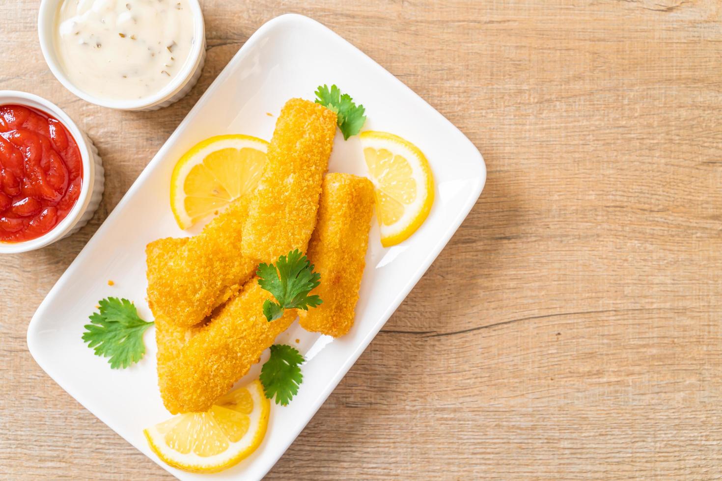 Fried fish finger sticks or french fries fish with sauce photo