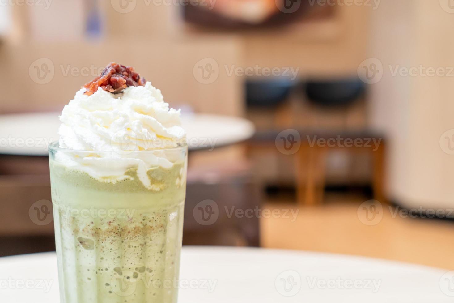 Matcha green tea latte blended with whipped cream and red bean in coffee shop cafe and restaurant photo